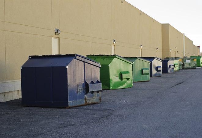 a row of blue construction dumpsters on a job site in Clinton, TN